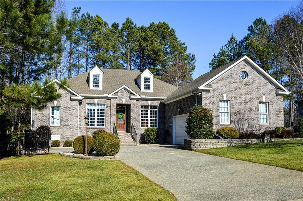 view of front of house with a garage and a front lawn