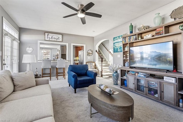 living room with light colored carpet and ceiling fan