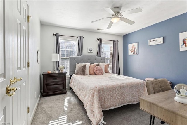 bedroom with ceiling fan and light carpet