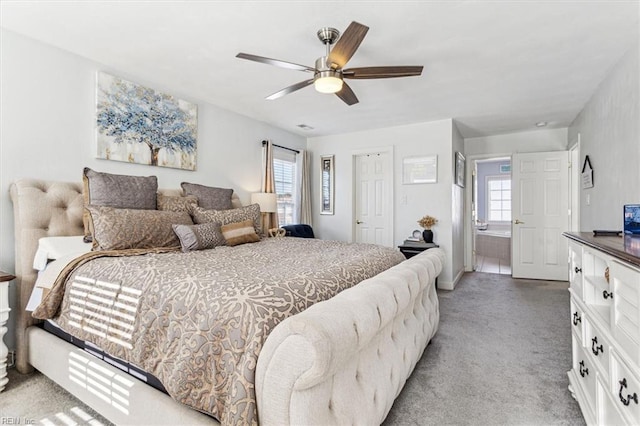 carpeted bedroom with ceiling fan and multiple windows