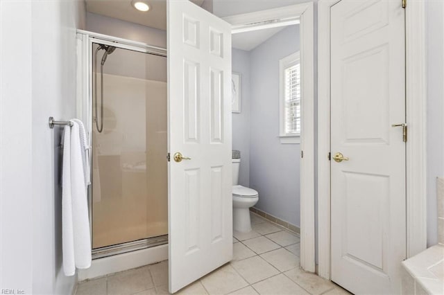 bathroom with tile patterned flooring, a shower with shower door, and toilet