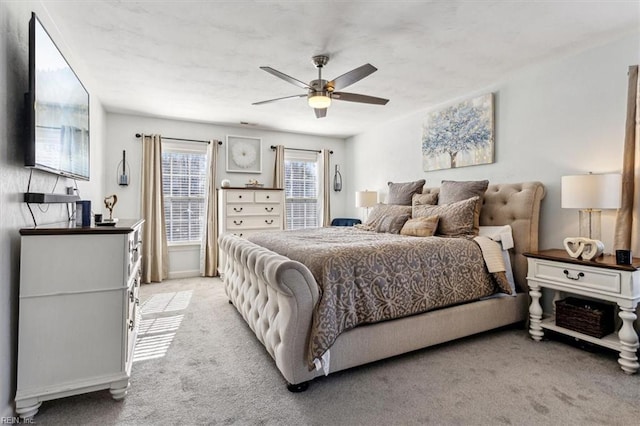 bedroom with light carpet and ceiling fan