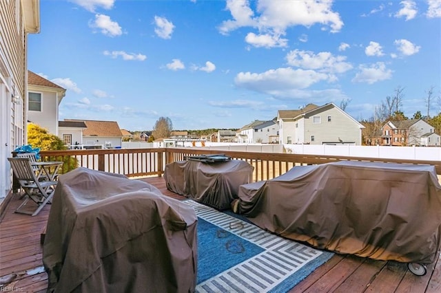 wooden terrace with a grill