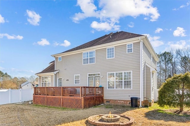 back of house featuring an outdoor fire pit and a deck