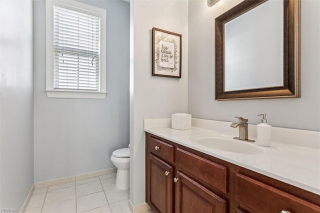 bathroom with tile patterned flooring, vanity, and toilet