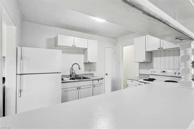 kitchen with sink, white appliances, and white cabinets