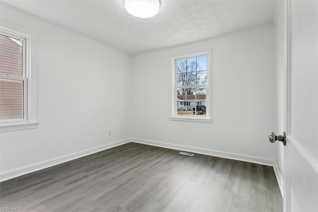 spare room with dark wood-type flooring