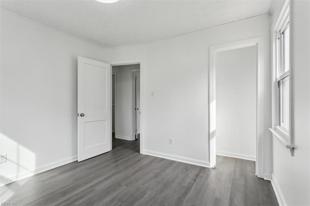 unfurnished bedroom featuring dark hardwood / wood-style flooring