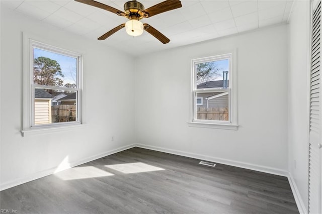 spare room with dark wood-type flooring and ceiling fan