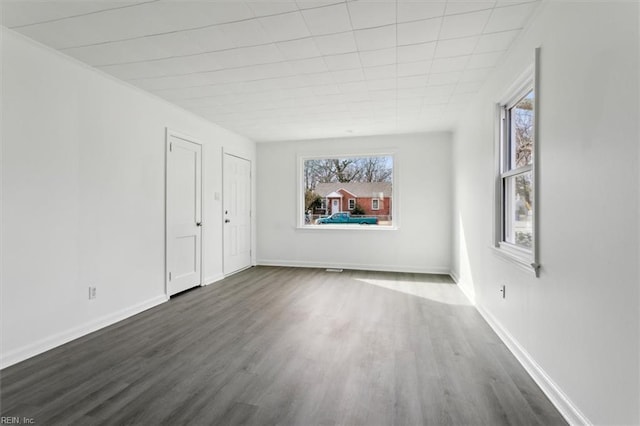 spare room with dark wood-type flooring