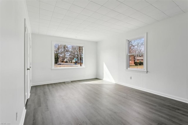 unfurnished room featuring dark wood-type flooring