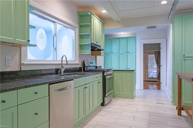 kitchen with beamed ceiling, sink, dark stone counters, green cabinets, and stainless steel appliances