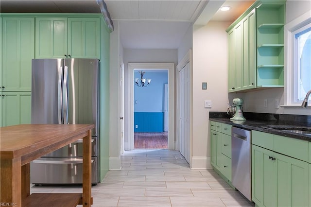 kitchen with appliances with stainless steel finishes, sink, and green cabinets