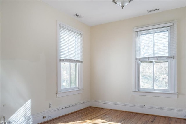 spare room featuring plenty of natural light and light wood-type flooring