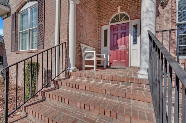 view of exterior entry featuring covered porch