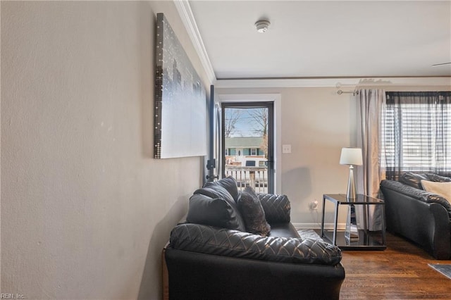 living room with ornamental molding, plenty of natural light, and dark wood-type flooring