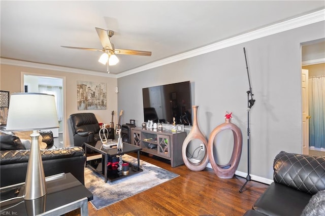 living room with crown molding, ceiling fan, and dark hardwood / wood-style floors