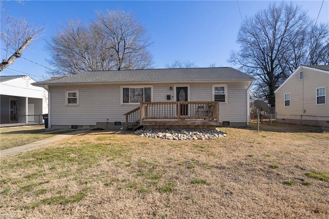 view of front of property with a wooden deck and a front lawn