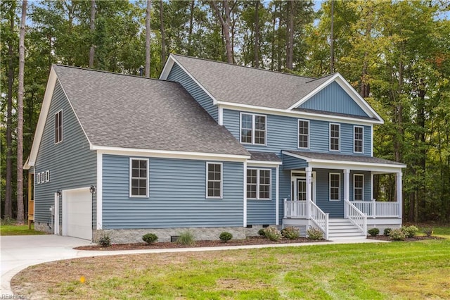 view of front of house with a garage, a front yard, and a porch