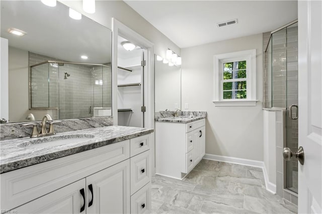 bathroom featuring vanity and a shower with shower door