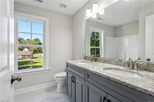 bathroom with vanity, plenty of natural light, and toilet