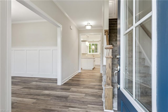 corridor with crown molding and hardwood / wood-style flooring