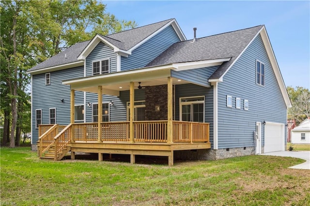 back of property with a garage and a yard