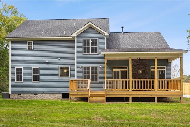 rear view of house featuring central AC unit, a deck, and a lawn