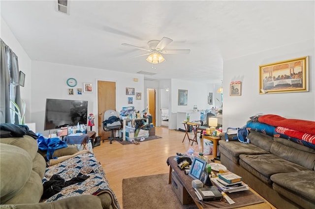 living room featuring ceiling fan and light wood-type flooring