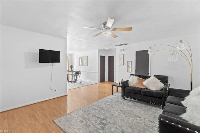 living room featuring hardwood / wood-style flooring and ceiling fan