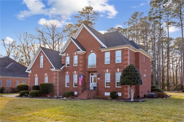 view of front of home with central AC unit and a front lawn