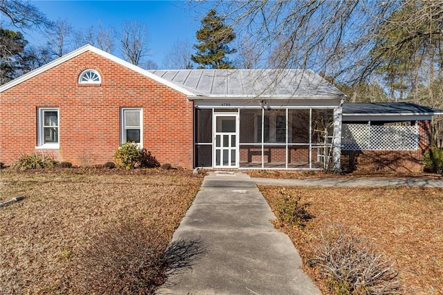 view of front of house with a sunroom