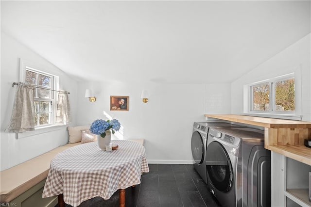 washroom featuring a healthy amount of sunlight and washing machine and clothes dryer