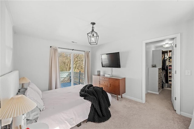 bedroom with access to exterior and light colored carpet