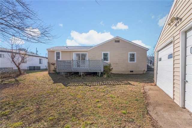 rear view of property with a wooden deck and a yard