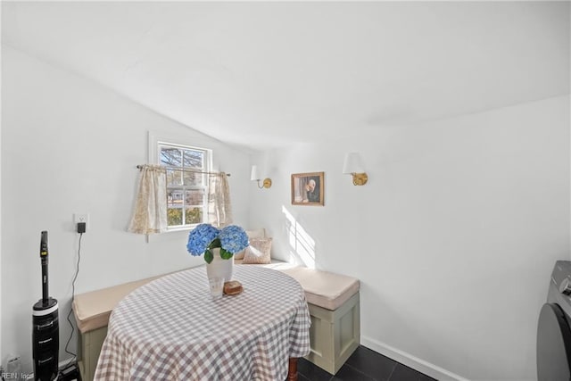 interior space featuring washer / dryer and vaulted ceiling