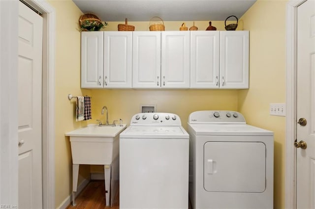 washroom with separate washer and dryer and cabinets