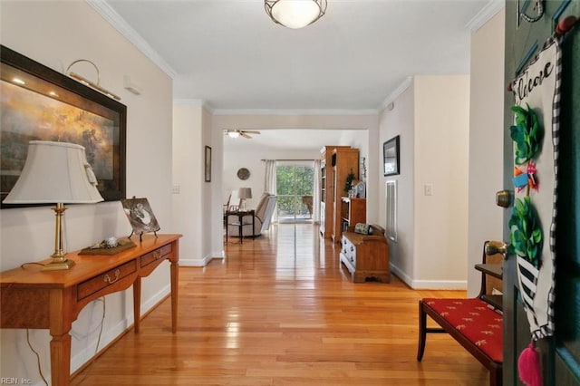 hall with crown molding and light hardwood / wood-style floors