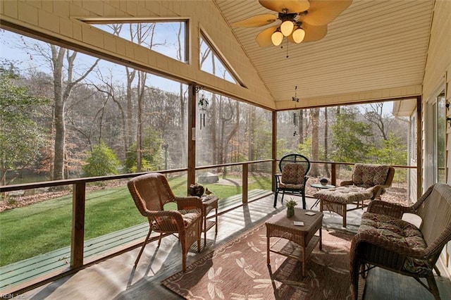 sunroom / solarium with ceiling fan, vaulted ceiling, and a wealth of natural light