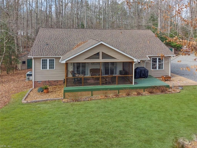 back of house featuring a yard and a sunroom