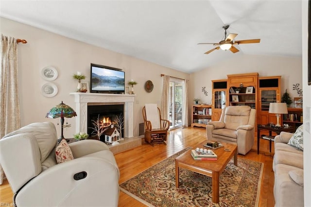 living room with vaulted ceiling, ceiling fan, and light hardwood / wood-style floors