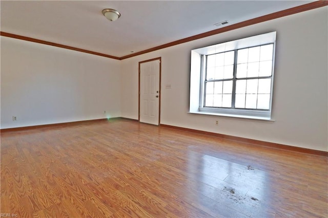 unfurnished room featuring light hardwood / wood-style flooring and ornamental molding