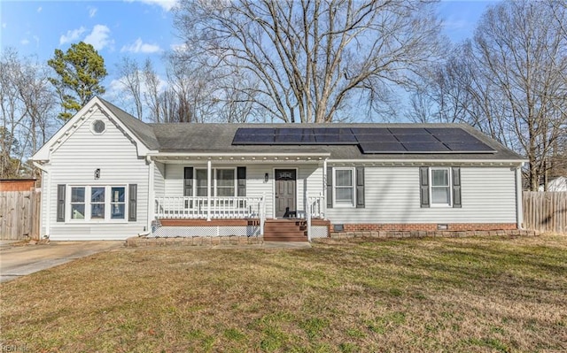 single story home with a front yard, covered porch, and solar panels