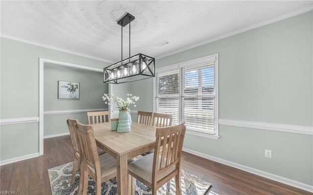 dining space featuring crown molding, dark hardwood / wood-style floors, and a textured ceiling