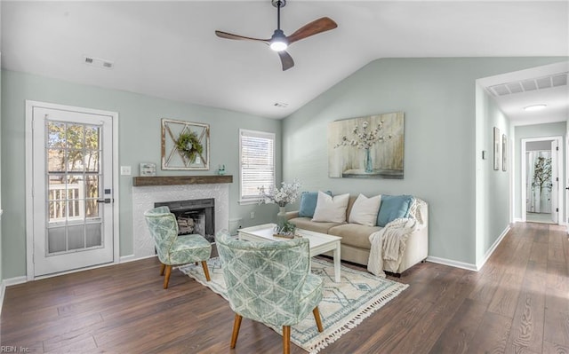 living room with dark wood-type flooring, vaulted ceiling, and ceiling fan