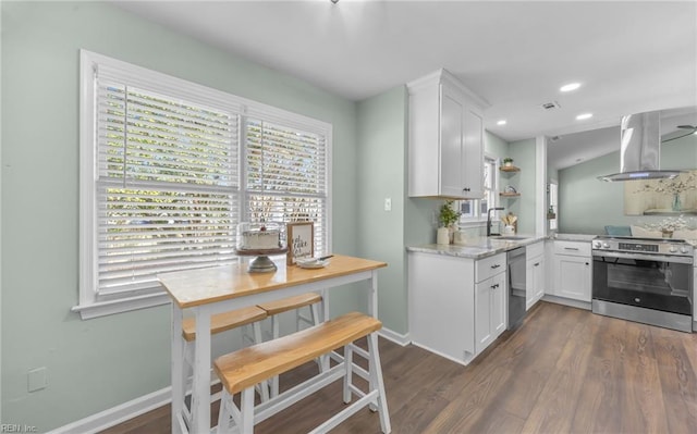 kitchen with white cabinetry, island exhaust hood, appliances with stainless steel finishes, and sink