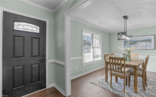 dining area featuring ornamental molding and dark hardwood / wood-style floors