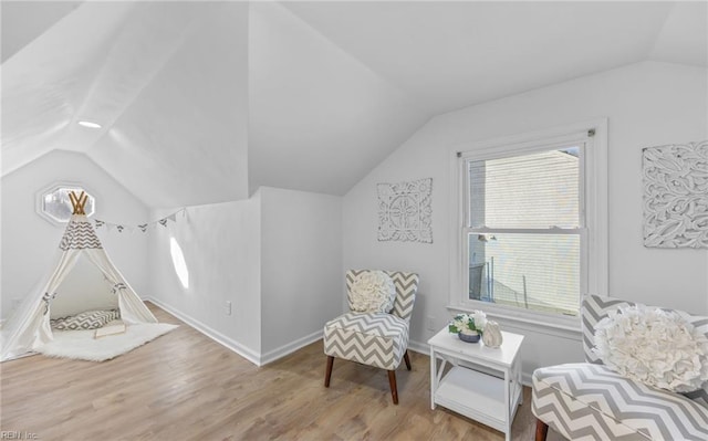 sitting room with vaulted ceiling, light hardwood / wood-style flooring, and a wealth of natural light