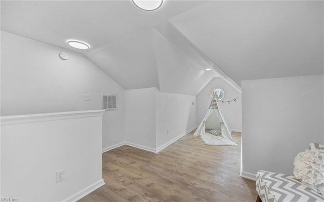 game room with lofted ceiling and light wood-type flooring