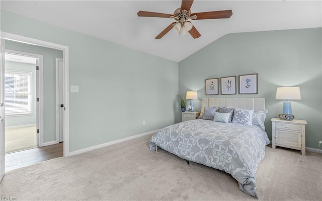 bedroom featuring ceiling fan, light colored carpet, and lofted ceiling